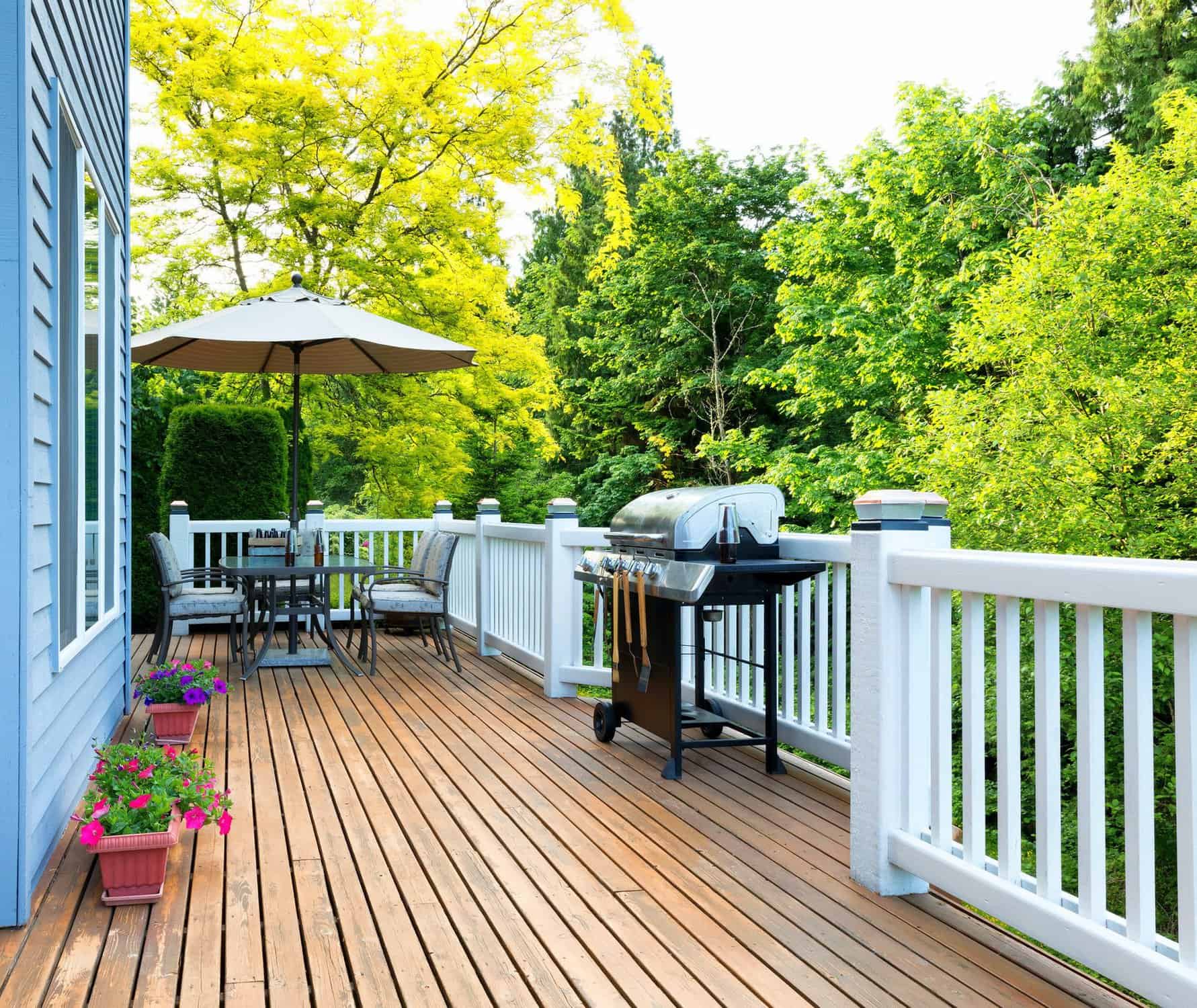 Honey Orange Stained Deck With White Railing Honey-orange stained wooden deck with white vinyl railings, outdoor seating, and grill in Raleigh, NC