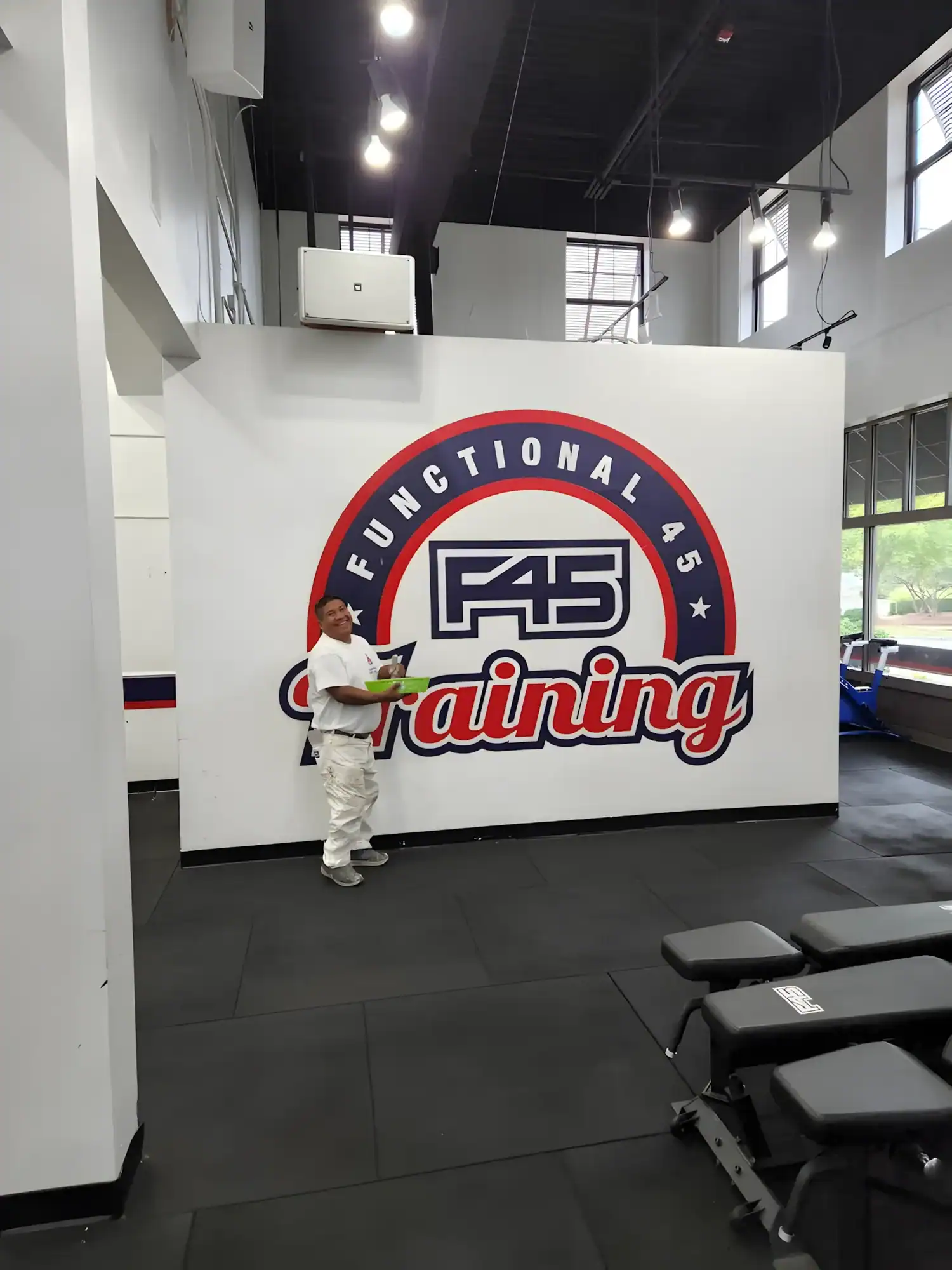 Functional 45 Training Gym Mural White interior gym wall with red, blue, and white painted Functional 45 Training logo mural in commercial fitness space