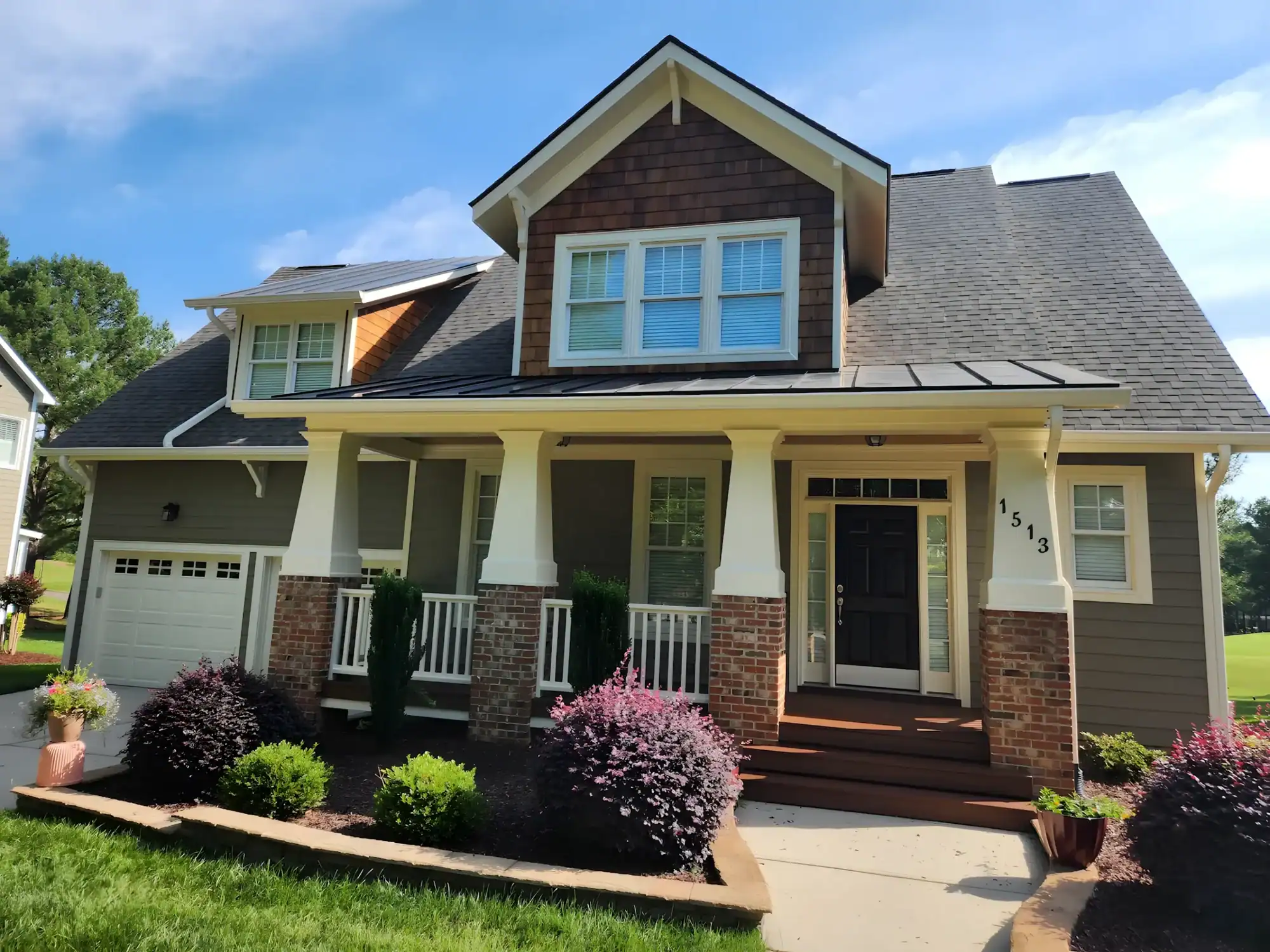 Cream and Brown Two-Story Home Cream-painted two-story residential home with dark brown upper gable, white railings, brick foundation, and black entry door