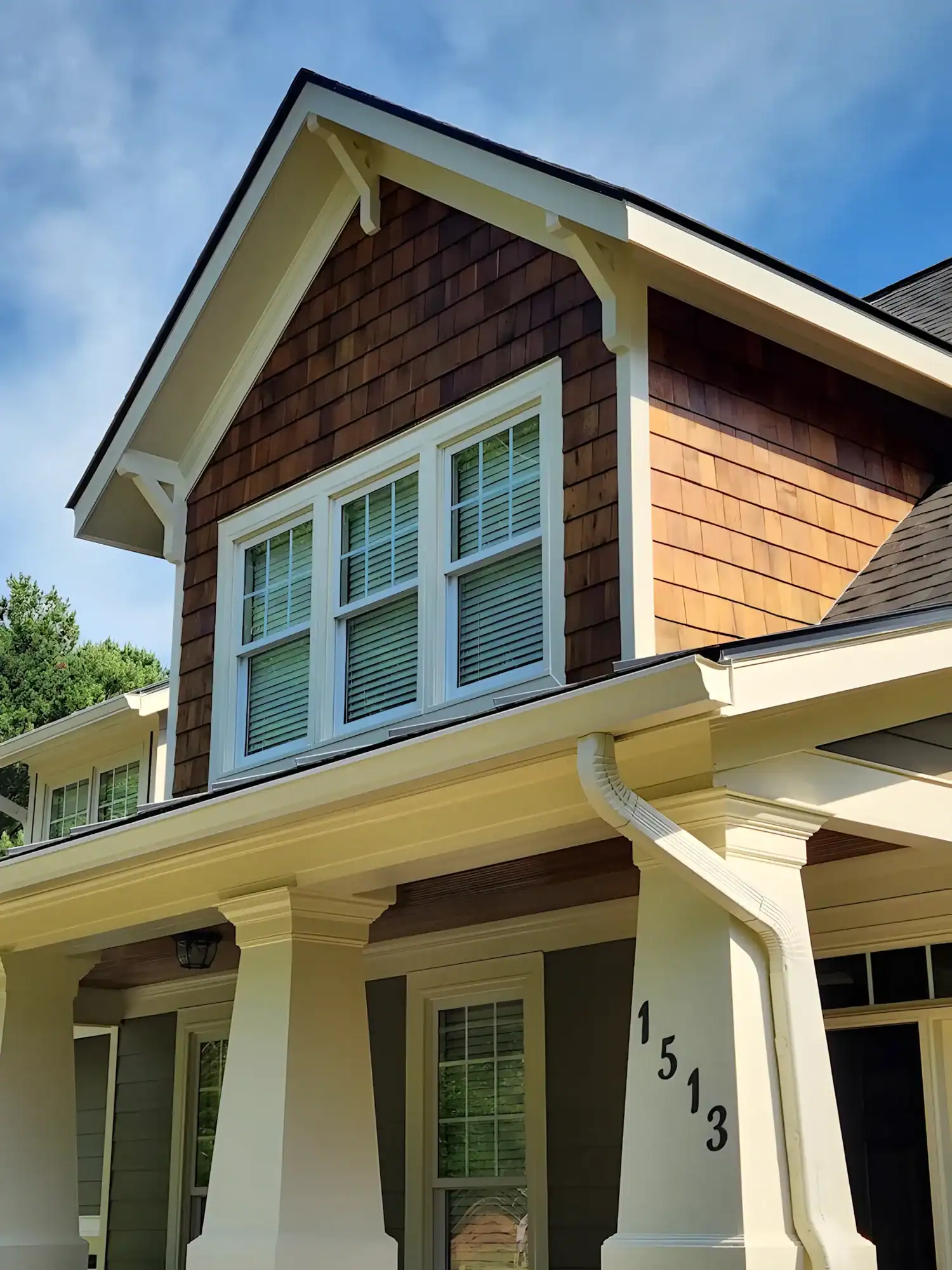 Cream And Brown Exterior Residential Home Cream-painted two-story residential home with dark brown cedar-shake siding, cream trim, and front porch in Raleigh, NC